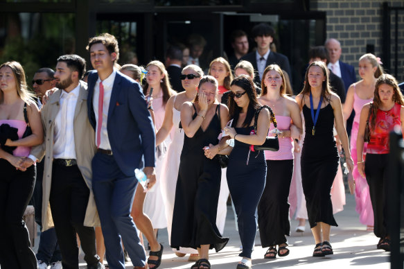 Guests leave the funeral service on Monday.