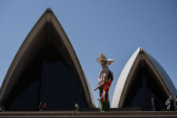 A spectator is seen wearing a Sydney Opera House tribute upon his head. 