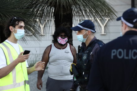 Police question a protester at Sydney University during a demonstartion over cutbacks.