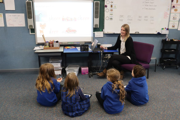 Teacher Maddison Flens with students at Tylden Primary School, which transformed its approach to teaching reading.