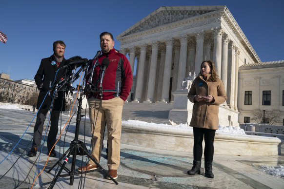 Brandon Trosclair, a grocery store owner that is challenging the Biden administrations vaccine mandate, talks to reporters outside the Supreme Court.