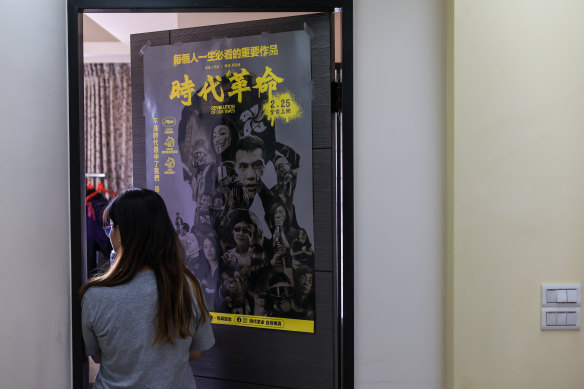 Candy with a poster for Hong Kong film Revolution of Our Times on her bedroom door in Taipei. 