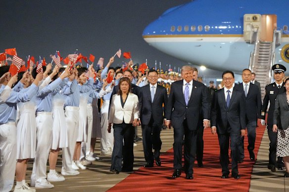 President Donald Trump walks with China’s Vice President Han Zheng during a welcome ceremony.