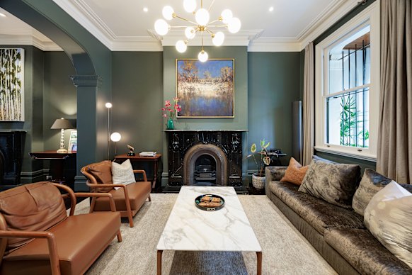 The four-level property was built around 1890 and retains its ornate ceilings and original timber floors, while a refreshed palette includes marble fireplaces, feature walls and designer lighting. 