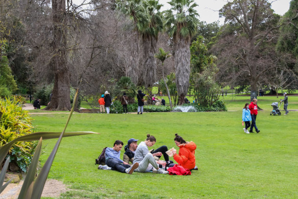 People are seen walking and having picnics at Treasury Gardens this month. 