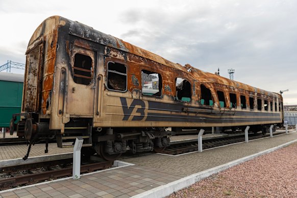 A damaged Ukrainian train carriage, struck by a Russian drone in an attack that killed six passengers, stands at the main railway station in Kyiv as a reminder of the danger to workers and passengers. 