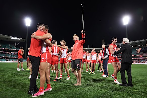 Callum Mills of the Swans celebrates victory with teammates.