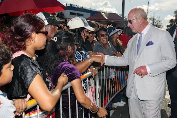 Charles greets people in Georgetown, Guyana, on Friday.