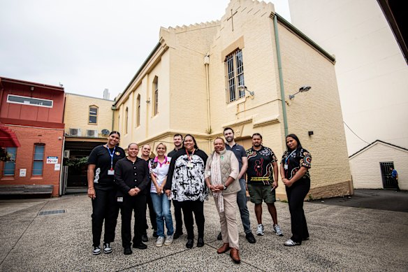 AMS Redfern chief executive officer LaVerne Bellear (front) with staff outside the Turner Street building.