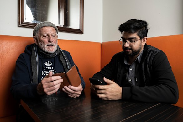 UTS international students helping seniors to use their phones, computers