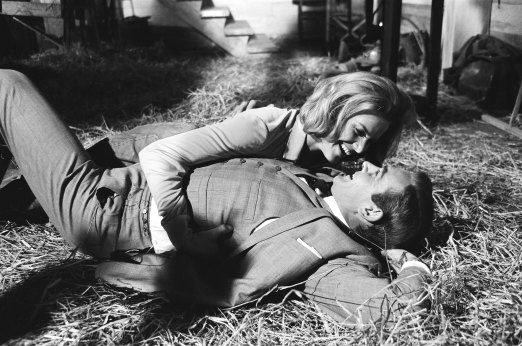 Honor Blackman as Pussy Galore and Sean Connery as James Bond filming a fight scene which develops into a love scene in Goldfinger.