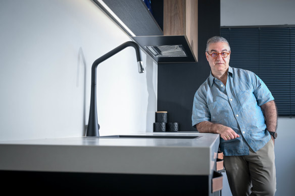 Mint Kitchens owner Frank Iaria leaning against an engineered stone bench in his Moonee Ponds showroom.