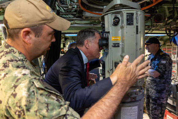 Deputy Prime Minister Richard Marles operates the periscope of submarine USS Asheville at HMAS Stirling in Western Australia. 