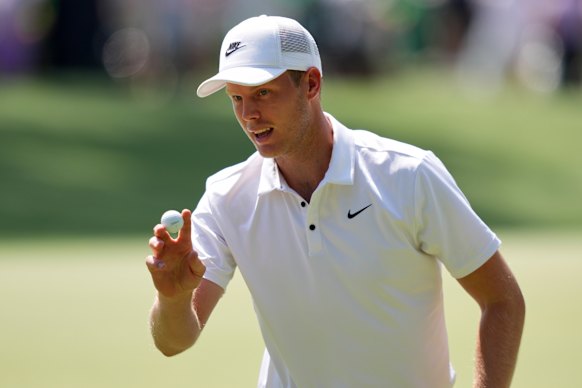 Cameron Davis waves to the crowd at Augusta. 