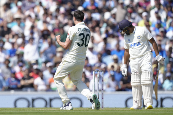 Pat Cummins celebrates taking the wicket of Rohit Sharma.