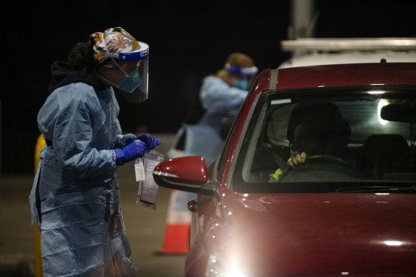 SydPath staff conduct COVID-19 tests at the 24-hour drive through clinic at Fairfield Showground. 