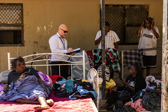 Rose Spencer (left) and other family members speak with police at Old Timers Camp on Thursday.