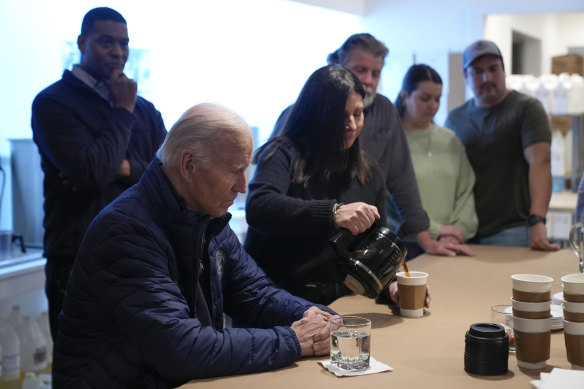 Owner Melissa Smith pours coffee brewed from tap water for US President Joe Biden in an East Palestine cafe.
