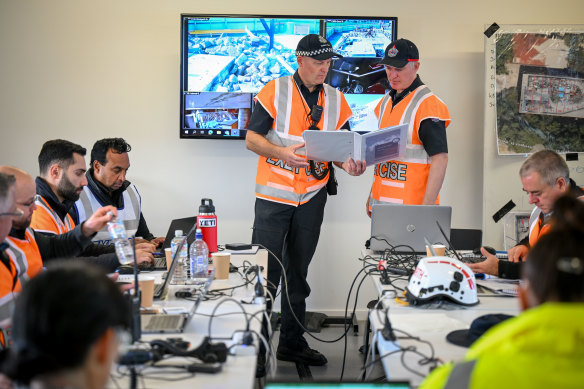 Victoria Police Senior Sergeant Jason Behan (left) and fire rescue commander Luke Klein inside the control room. 