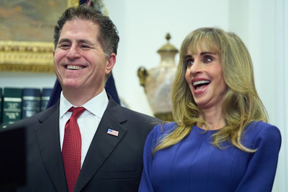 Michael Dell, and his wife Susan, laugh as Trump speaks.