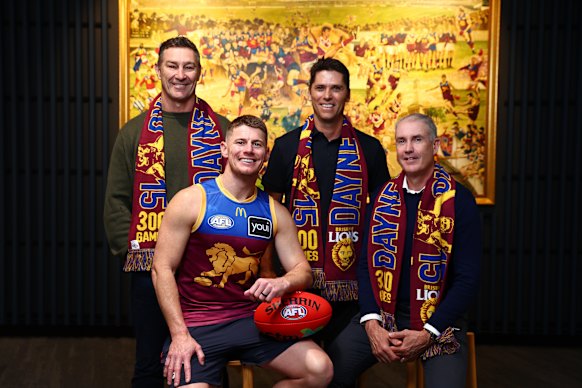 Zorko poses with 300 game members Alastair Lynch, Simon Black and Marcus Ashcroft.