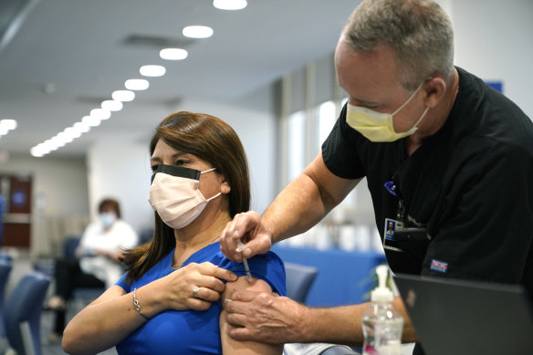 A nurse receives a Pfizer COVID-19 booster shot at a hospital in Miami this month.