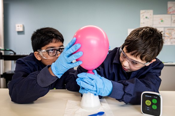 Students conduct a science experiment.