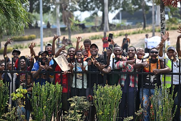 Fans look on after the Samoa team arrives in Port Moresby.