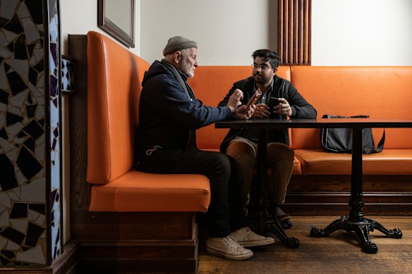UTS international students helping seniors to use their phones, computers