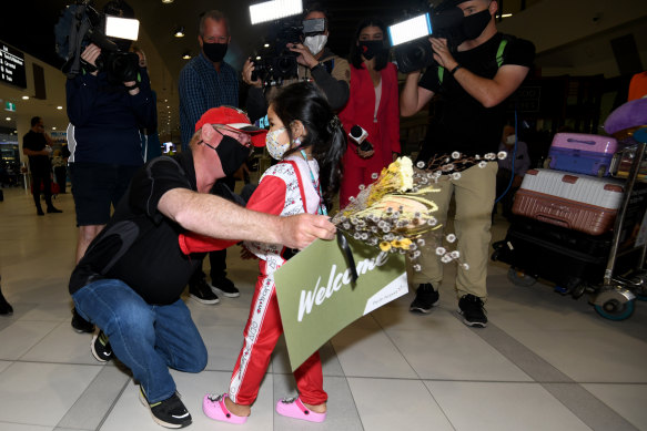 Stewart Maddison greets his granddaughter Maple and daughter Mai at Perth airport after Western Australia’s borders opened to domestic and international travellers. 
