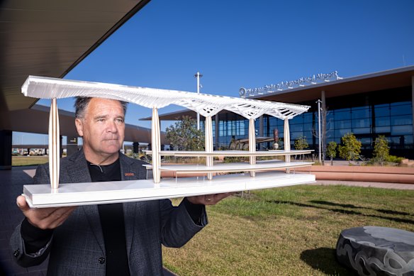 COX Architecture principal David Holm holds a model that aided work on the terminal’s concept design.