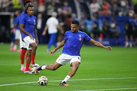 Kyliam Mbappe warms up in Dallas.