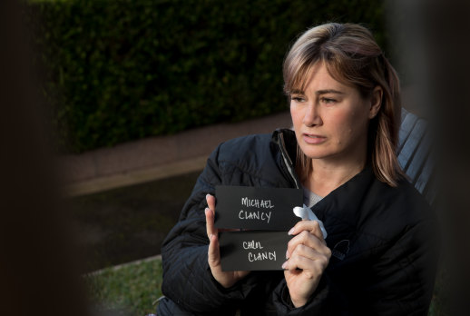 Jane Malcolm with names of her mum, and step-dad, Carol and Michael Clancy, which were hung outside of the Russian Consulate in Sydney in 2019.