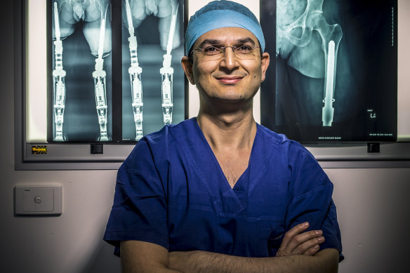 Dr Munjed Al Muderis, pictured in 2014 in his surgical scrubs.