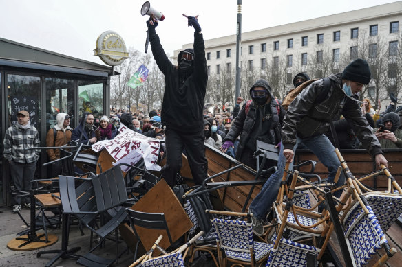 Protesters stand on a barricade during a demonstration in Lyon, central France.