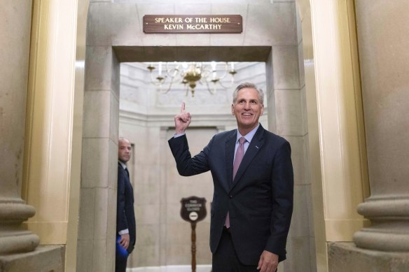 Speaker of the House Kevin McCarthy points to the newly installed nameplate at his office after he was sworn in as speaker of the 118th Congress in Washington.