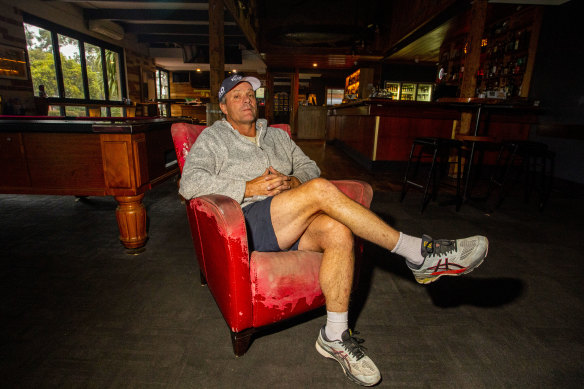Mallacoota Hotel owner Lou Battel sits in the empty bar.