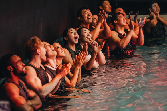 Contestants cheer each other on from the sidelines during a physical challenge.