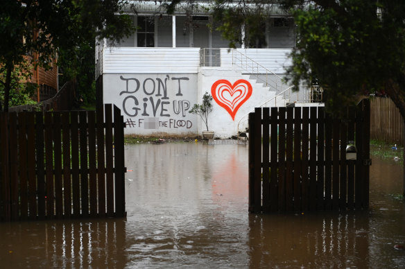 Floodwater approaches a house in Lismore on Tuesday morning.