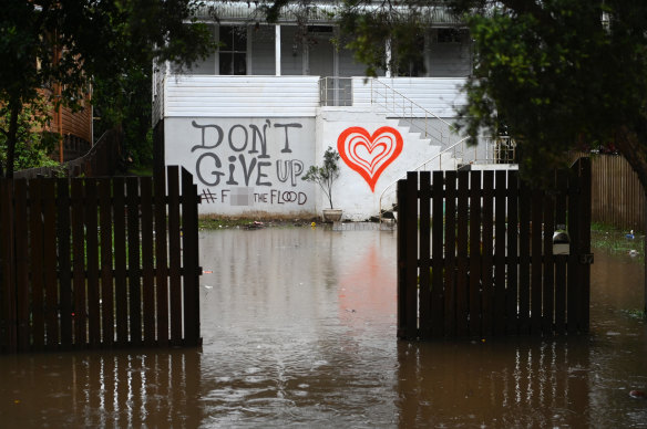 Floodwaters reach a house in Lismore on Tuesday morning.