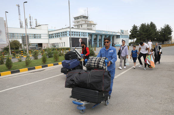Passengers outside the main terminal at Kabul airport. Thousands of people were trying to flee the Afghan capital as the Taliban took charge of the city.