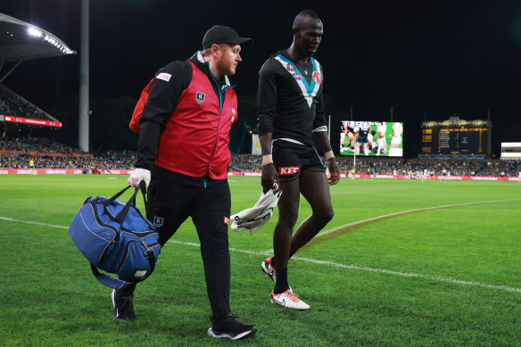 Aliir Aliir comes off injured at Adelaide Oval.