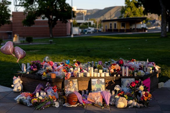 Pictures, flowers and candles mark a makeshift memorial for the three young girls.
