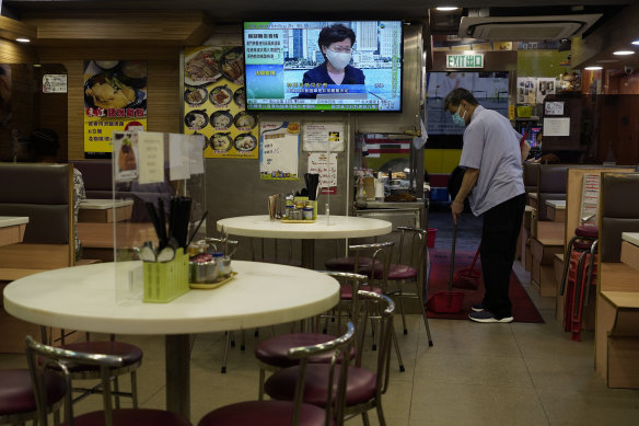 A TV in a Hong Kong restaurant broadcasts Chief Executive Carrie Lam during a press conference.