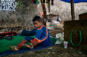 Firmansyah, 8, gets ready for another race. Firmansyah fell from his horse the day before and was concussed, but said he felt ready to ride again.