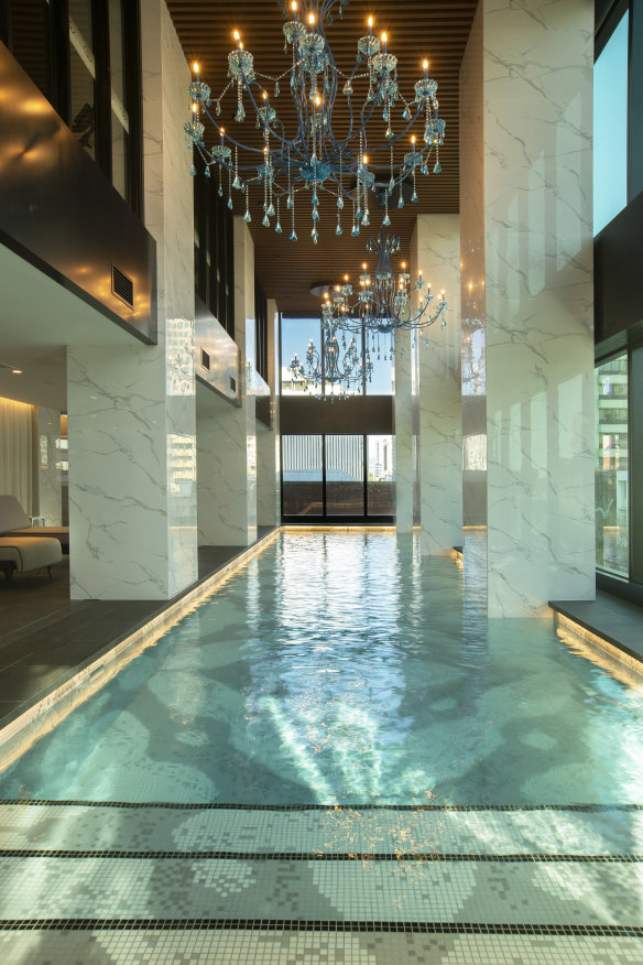 Sofitel’s indoor pool is softly lit by three blue chandeliers.
