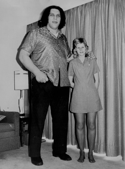 Wrestler Andre the Giant, 7ft 5in tall, stands next to hotel employee Wendy Owsinski, 19, 5ft 9 in tall.