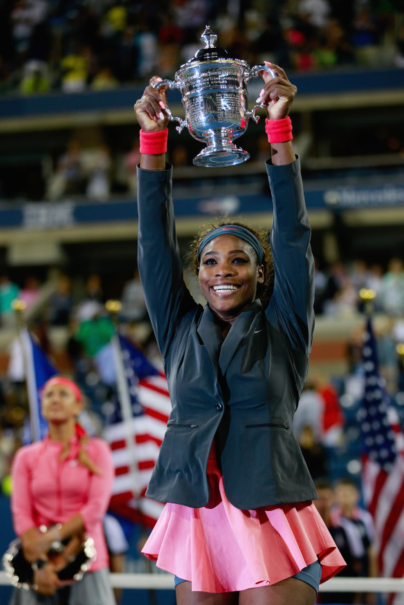 Williams holds aloft her 2013 US open trophy.