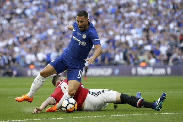 Red handed: Manchester United's Phil Jones, on the ground, fouls Chelsea's Eden Hazard in the box.