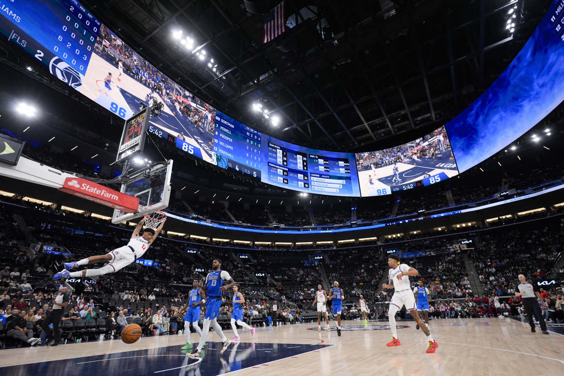 Los Angeles⁤ Clippers’ ⁣Cam Christie (12) throws down a dunk at​ the Intuit Dome ⁢during preseason.
